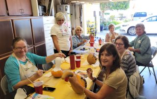 Members painting gourds for Halloween