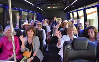 Participants riding the bus at the 2022 Gate and Garden Tour