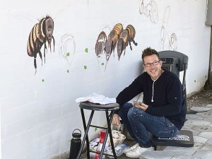 Artist Matt Willey begins painting the Bee Mural at the Water District offices in Laguna Beach
