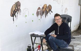 Artist Matt Willey begins painting the Bee Mural at the Water District offices in Laguna Beach
